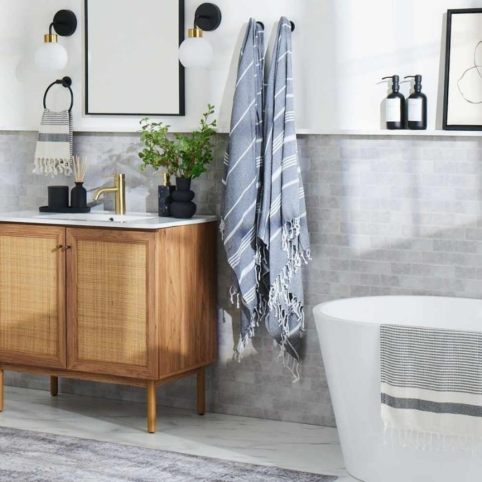 Light grey tiles with wooden vanity in a modern bathroom