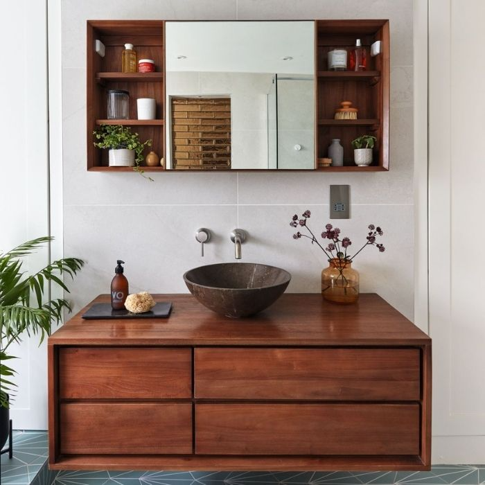 Bathroom with wooden vanity and black vessel sink