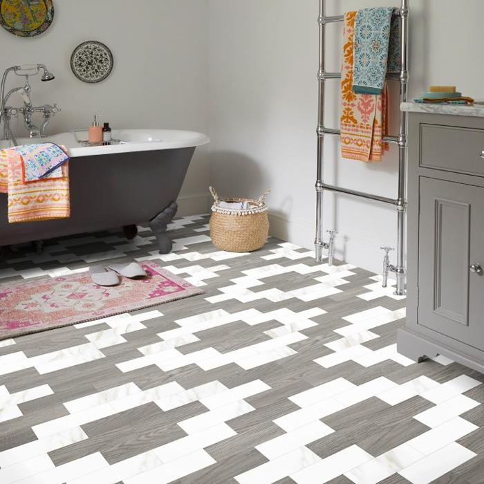 Eclectic bathroom featuring patterned floor tiles and colourful towels