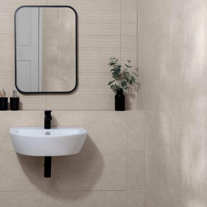 Minimalist bathroom with beige wall tiles and black accents