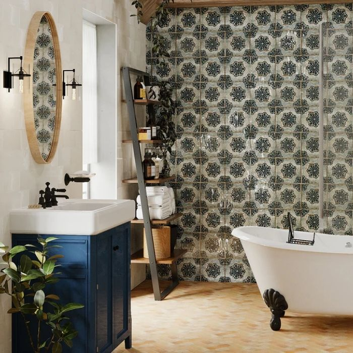 Clawfoot bathtub with patterned tiles and wooden accents