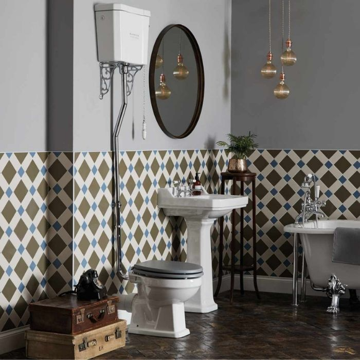 Diamond-patterned half-tiled wall with Victorian-style toilet