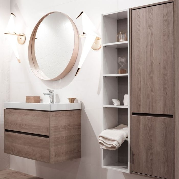 Wooden vanity unit with matching shelving and round mirror