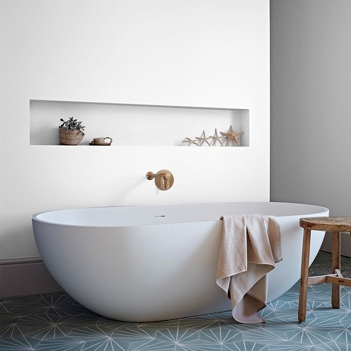 White painted walls with geometric patterned floor tiles in bathroom