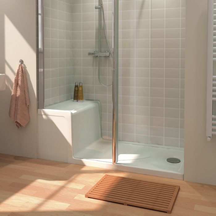 Small white tiles with a built-in seat in a raised shower