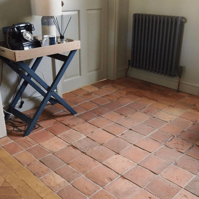 Small entryway with rustic terracotta floor tiles