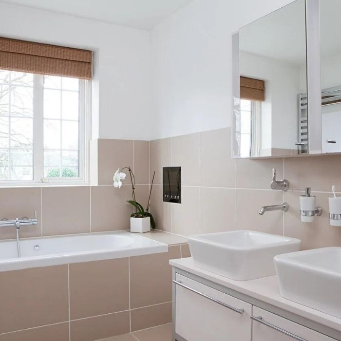 Neutral beige tiles in a bright bathroom