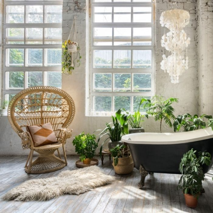 Industrial bathroom with large grid windows and greenery