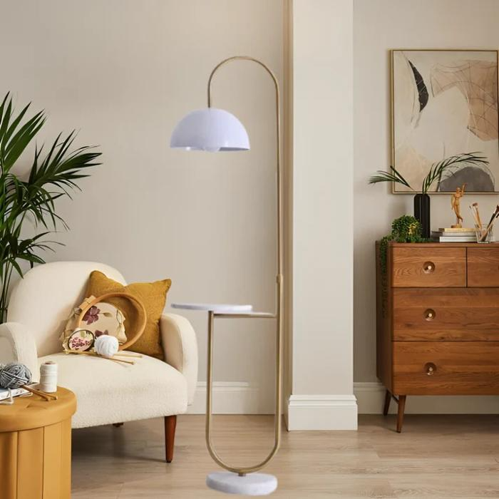 White dome floor lamp beside cosy armchair and wooden dresser