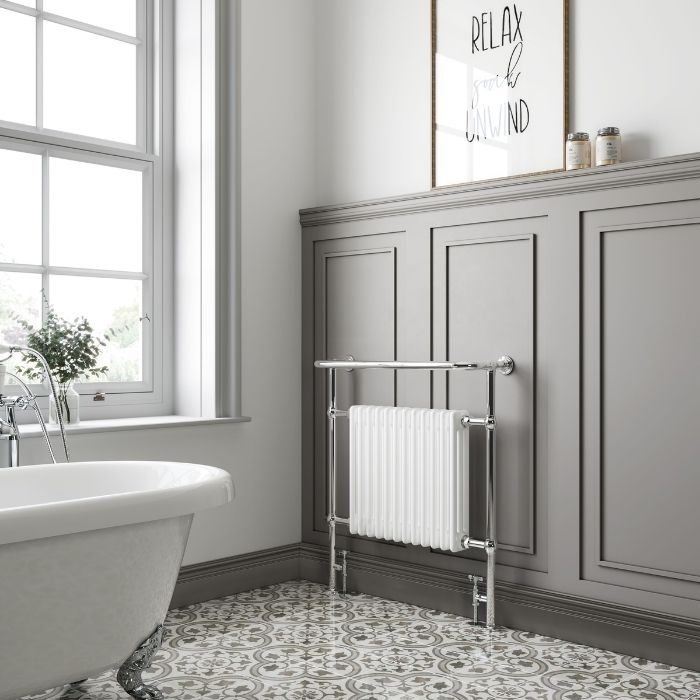 Patterned floor tiles with traditional wainscoting in bathroom