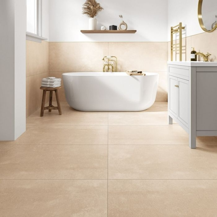 Beige bathroom with freestanding tub and large floor tiles