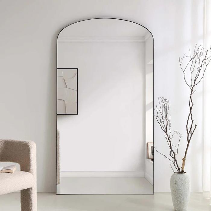 Arched mirror in a minimalist room