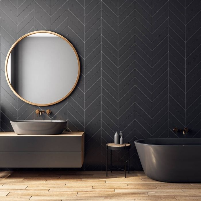 Black chevron tiles with wood flooring in modern bathroom