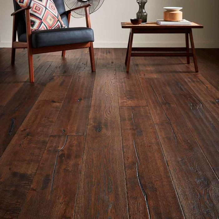 Dark solid oak flooring with modern armchair and table