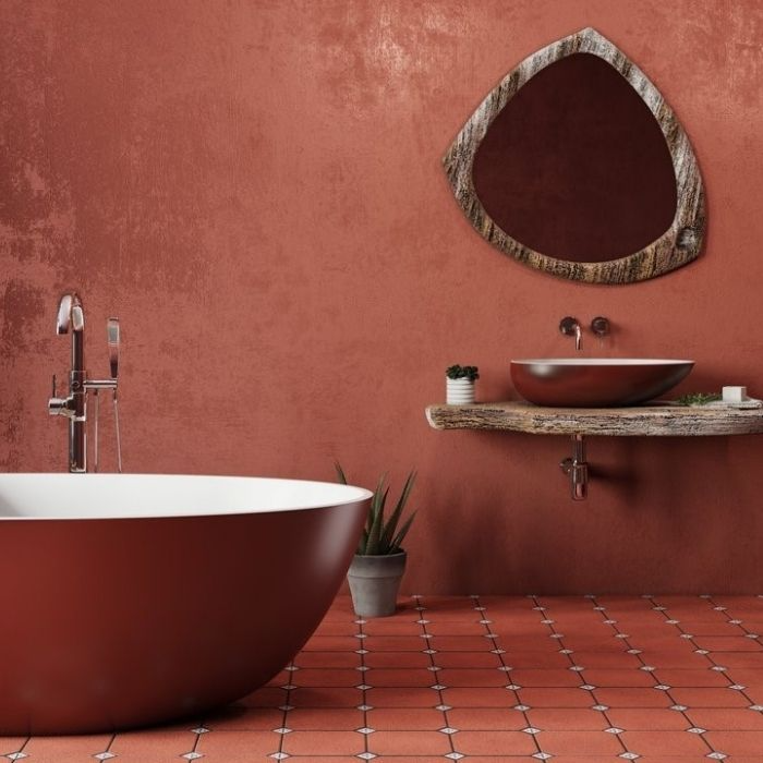 Terracotta painted walls with matching floor tiles and rustic décor