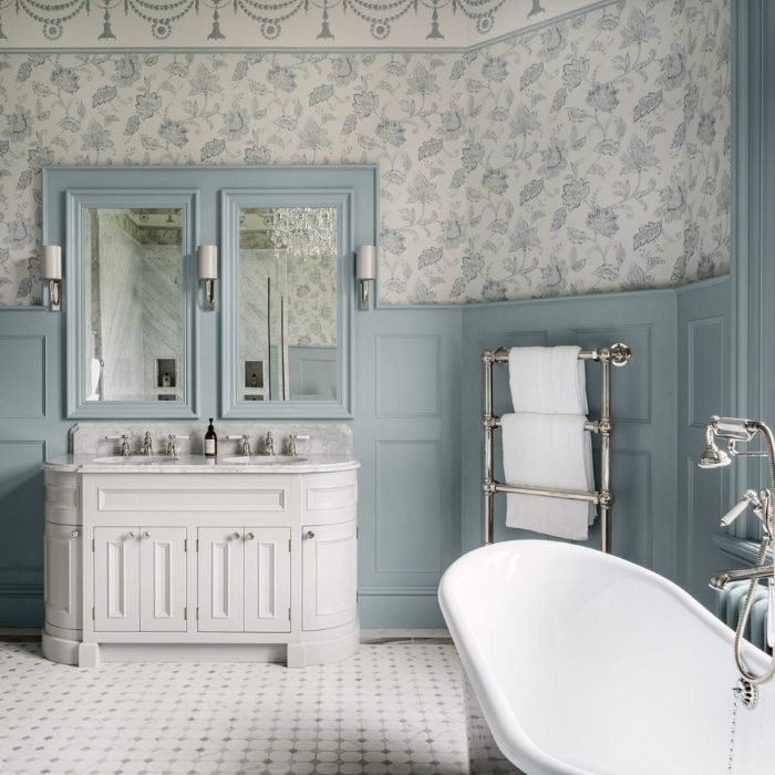 Country bathroom with blue wainscoting and floral wallpaper