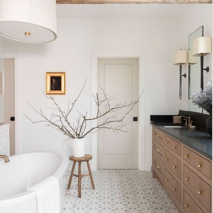 Patterned tile flooring with wooden vanity and black countertop