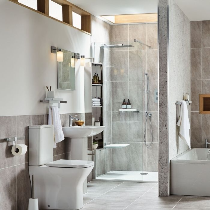 Large grey tiles with a raised shower tray and glass screen