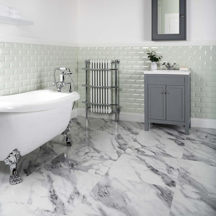 Grey marble tiles underneath a clawfoot tub