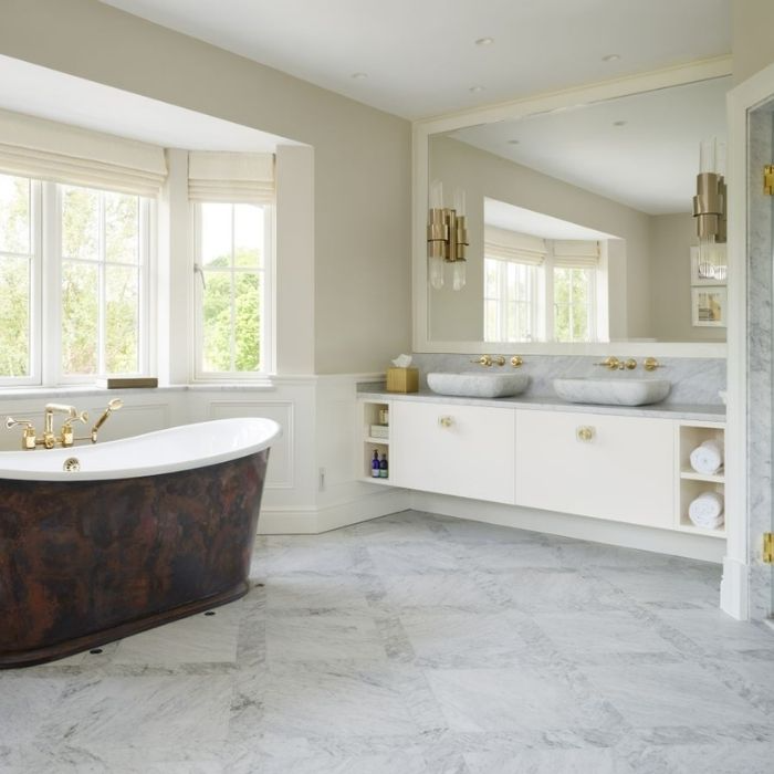 Freestanding bathtub with marble flooring and double vanity