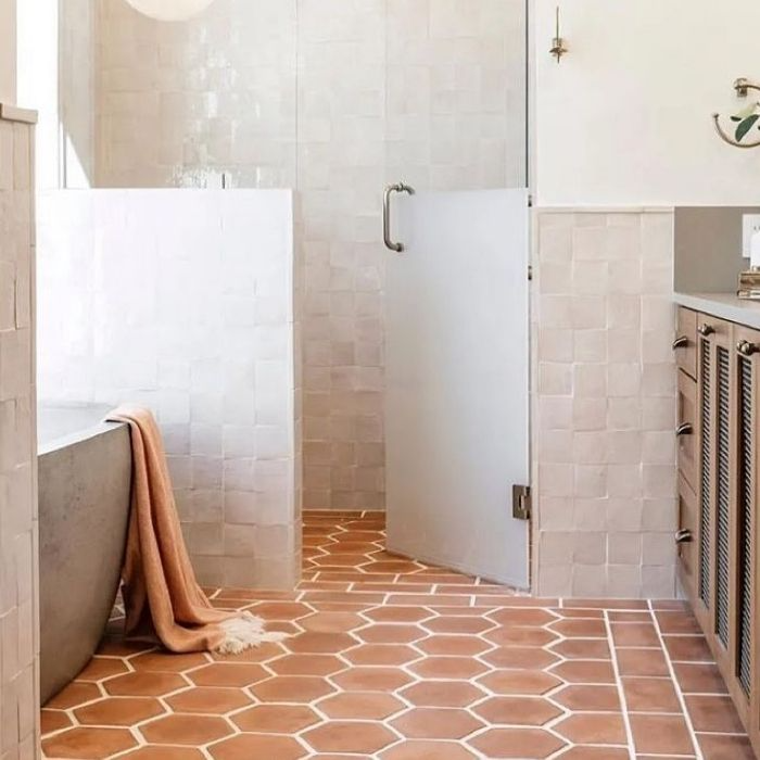 Bathroom with terracotta hexagon floor tiles and white walls