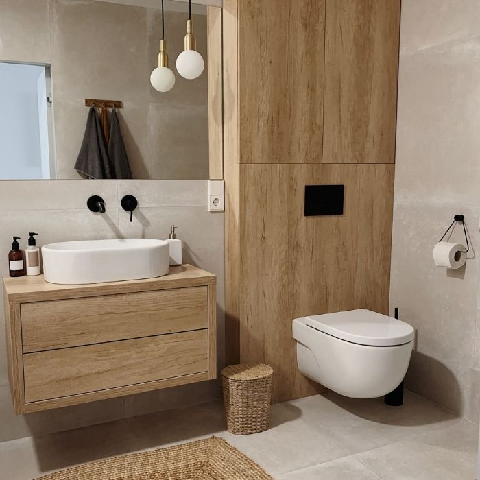 Wooden vanity and wall panels with white basin in bathroom