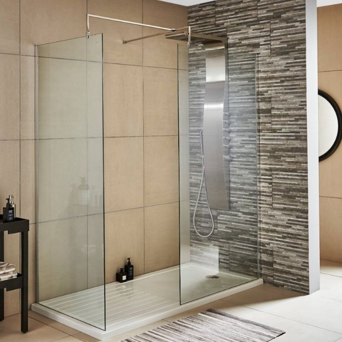 Textured grey feature wall with a raised shower tray