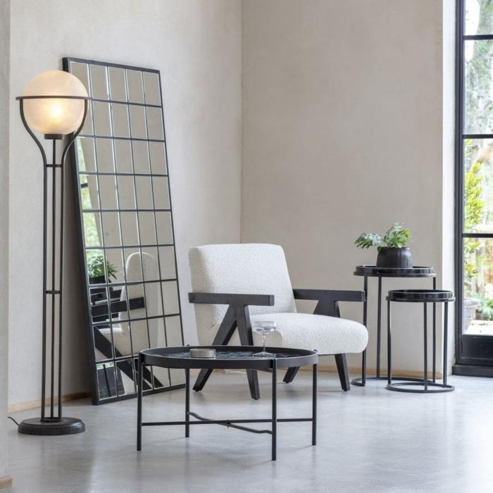 Black, grid-style floor mirror in modern living room