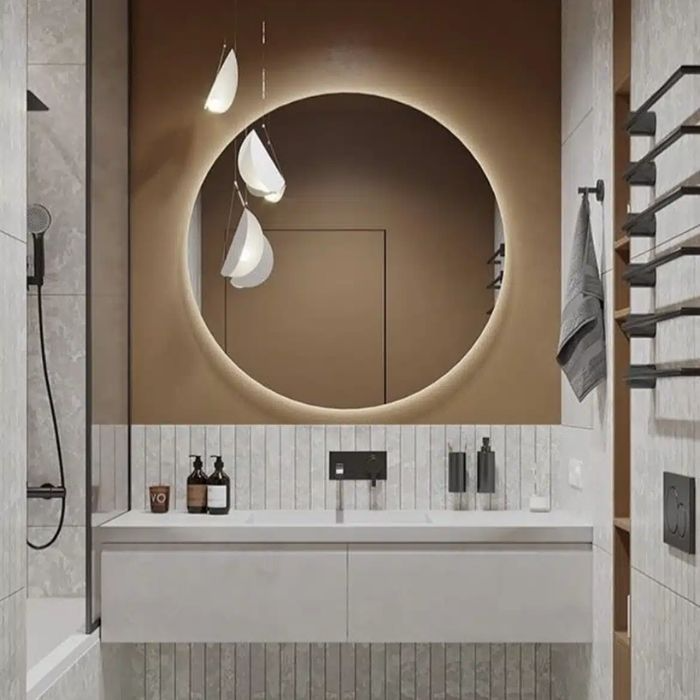 Bathroom with circular mirror and vertical striped wall tiles