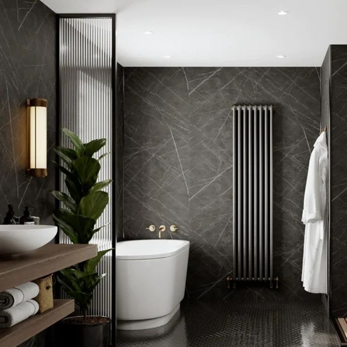 Black marble tiles with gold accents in luxurious bathroom