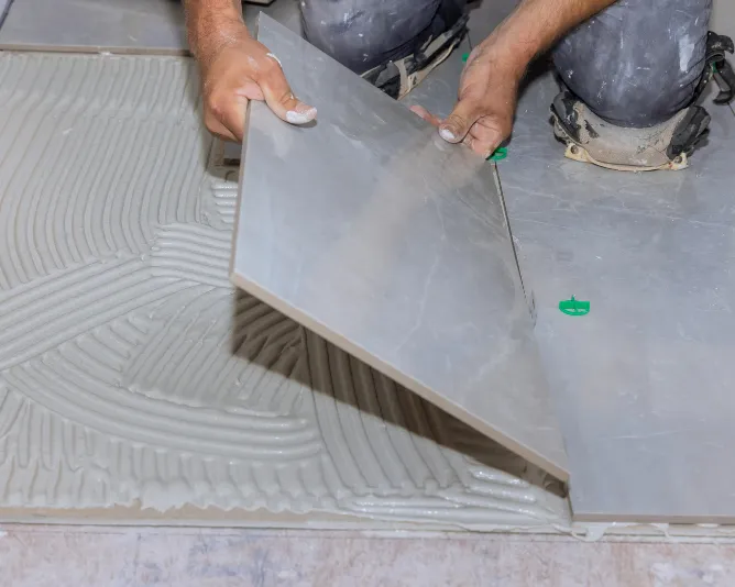 person sealing porcelain tile with clear sealant