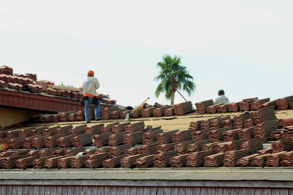 roofer installing ridge tiles roofing