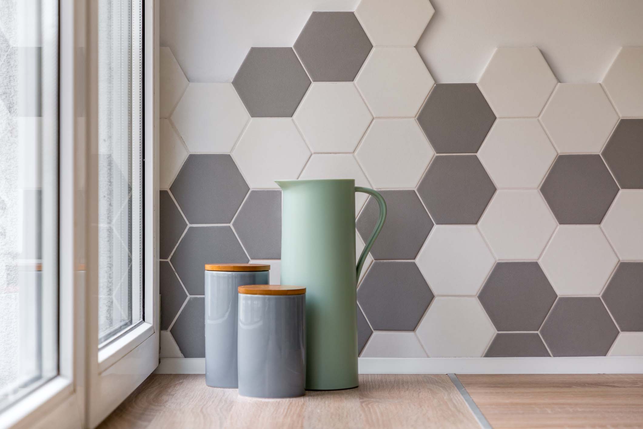Hexagonal tiles create a modern and stylish kitchen backdrop.