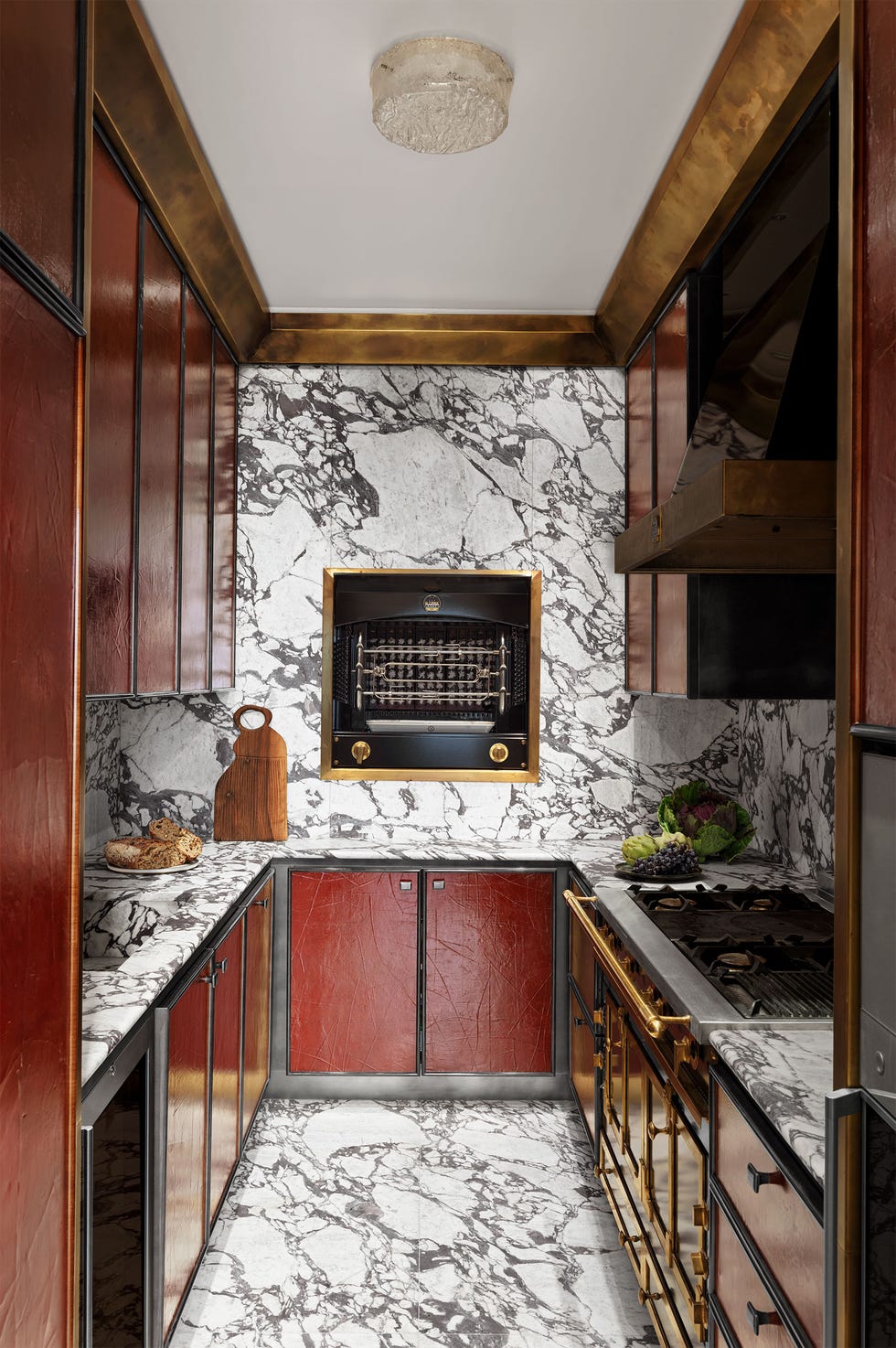 Luxurious marble and brass accents enhance kitchen's elegant charm.