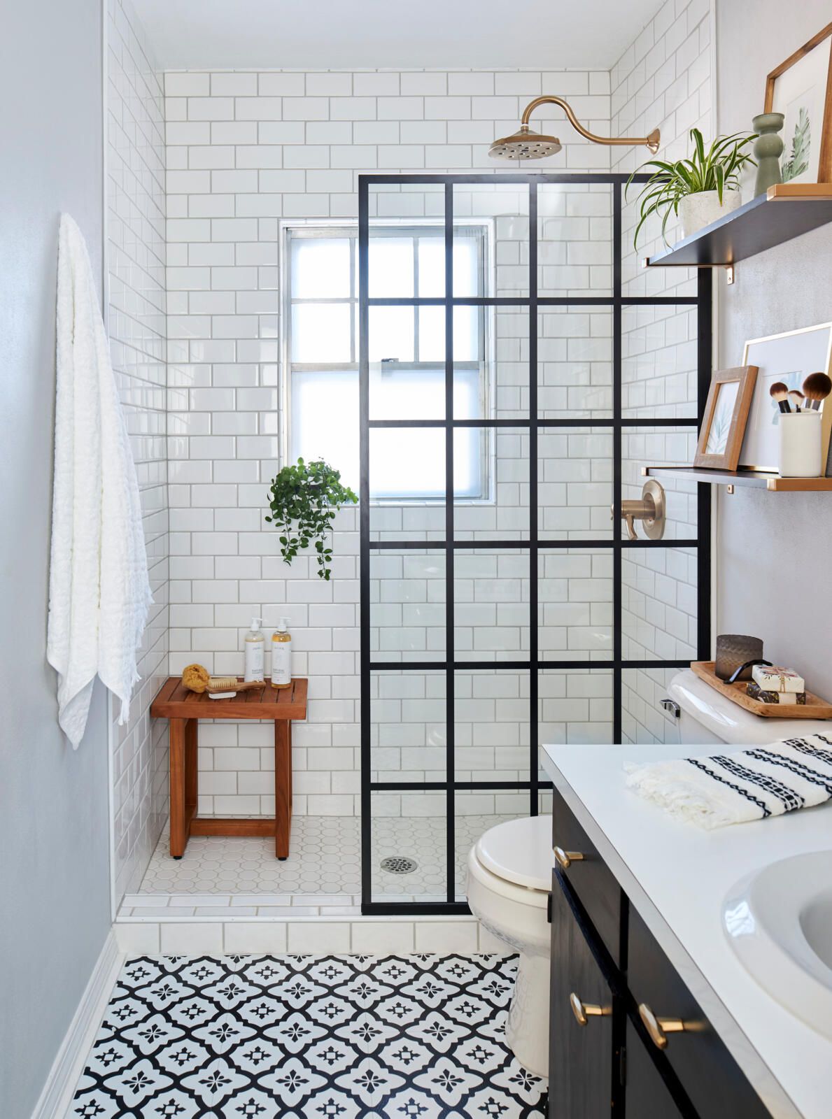 Modern small bathroom with patterned tile flooring and minimalist decor.