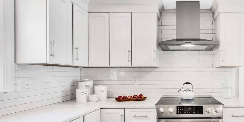 Sleek modern kitchen with white subway tile backsplash design.