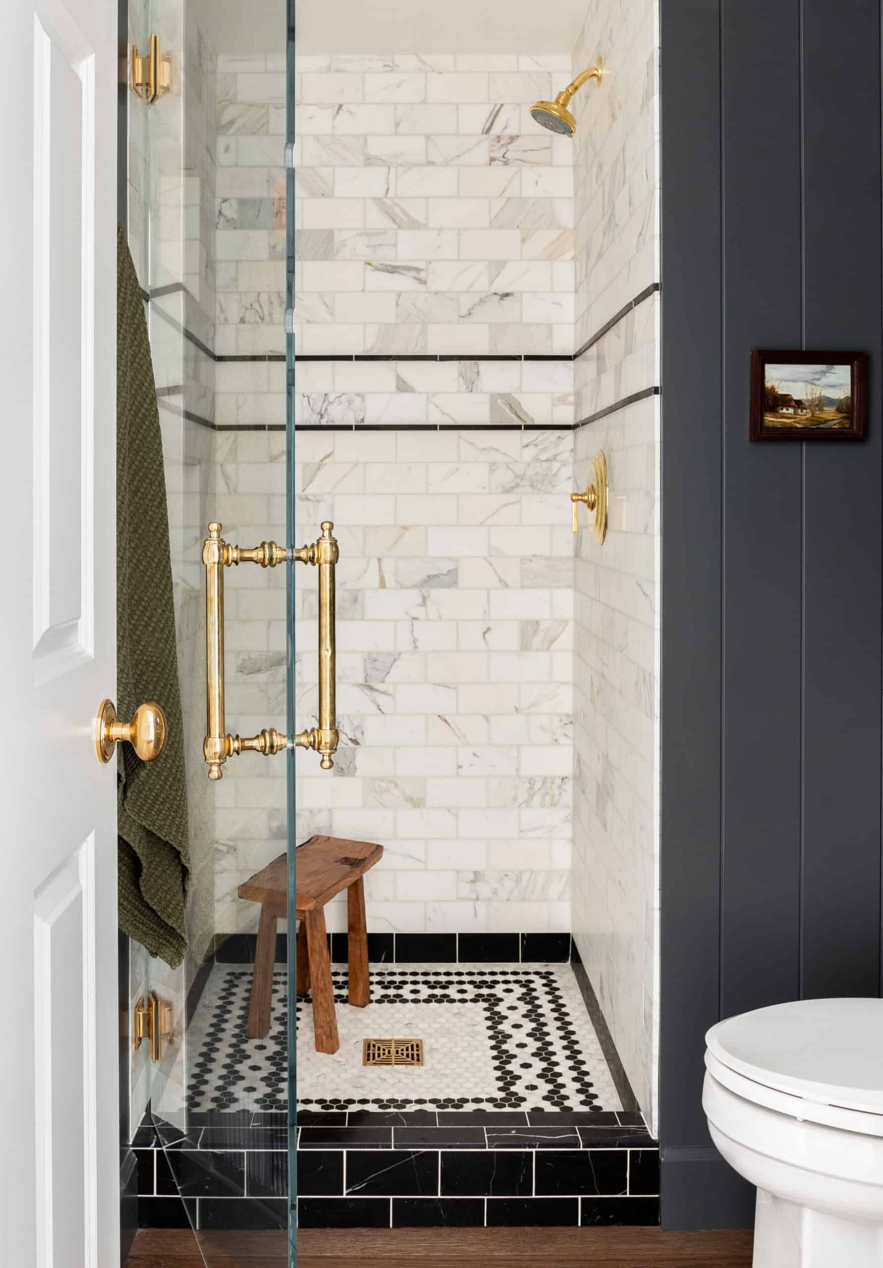 Stylish marble and tile flooring in a small bathroom.