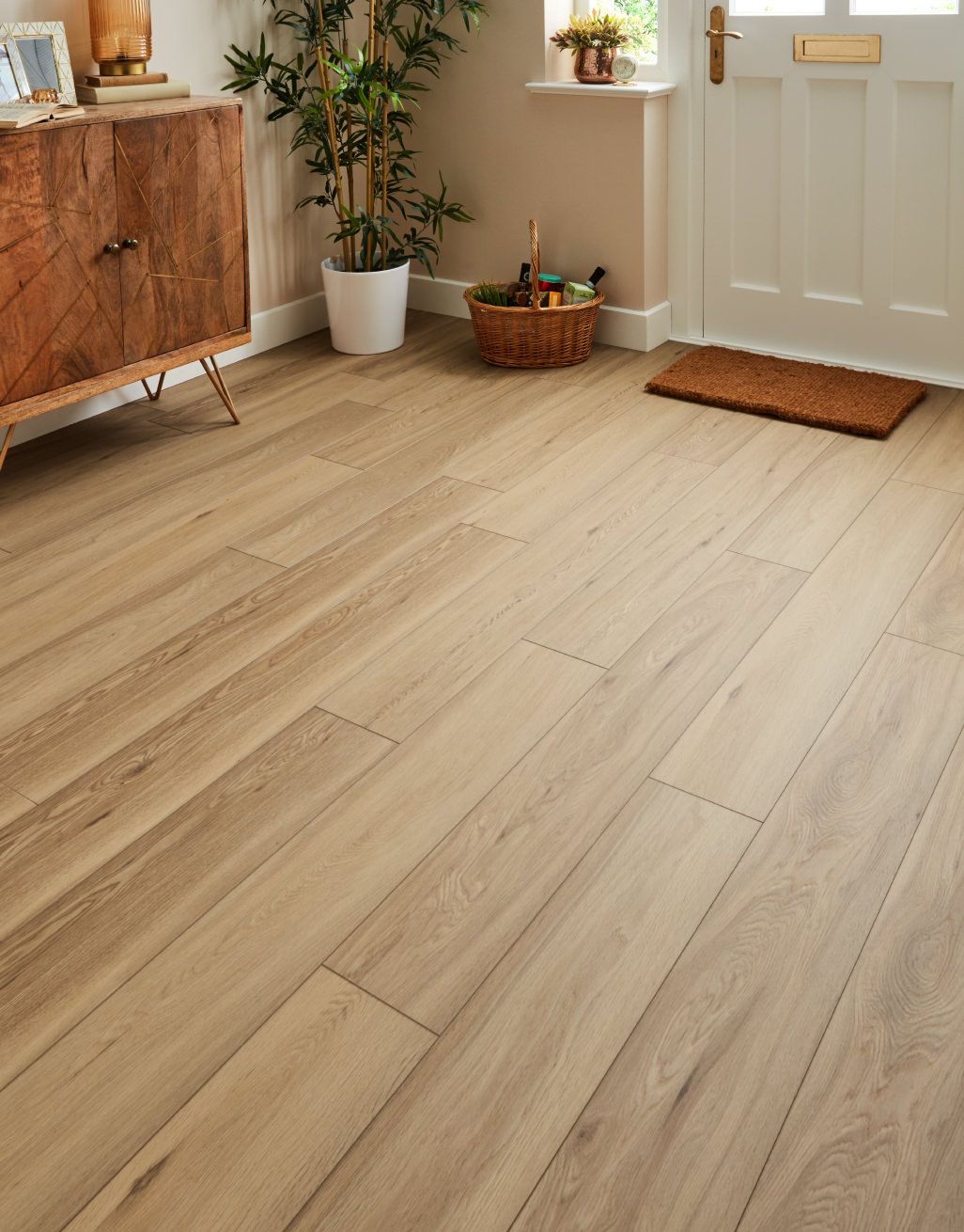 Stylish wooden flooring in warmly decorated modern entryway.
