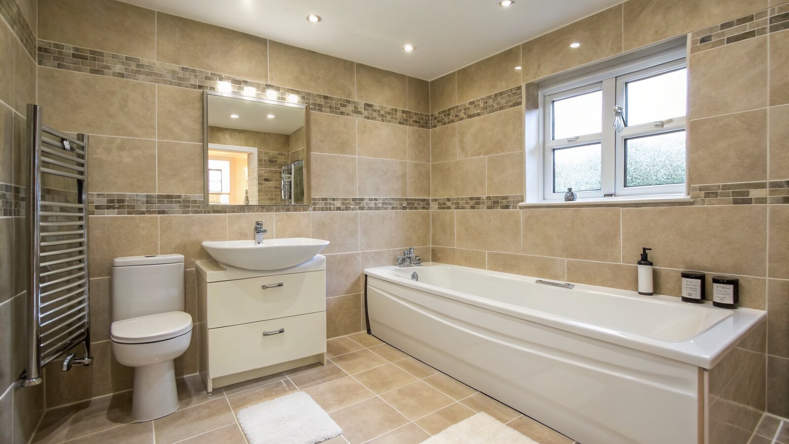 A fully tiled bathroom with walls and floor completed
