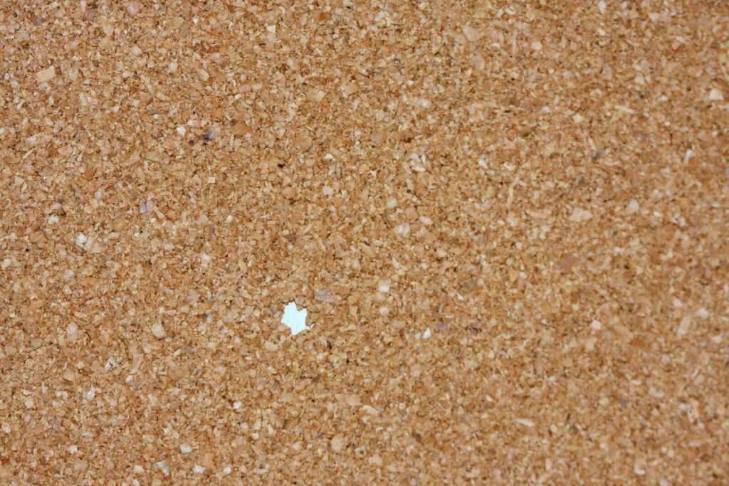Close-up of natural cork material showing its granulated cellular texture