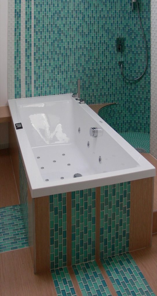 Bathroom with mosaic and wall tiles whose grout lines benefit from sealing