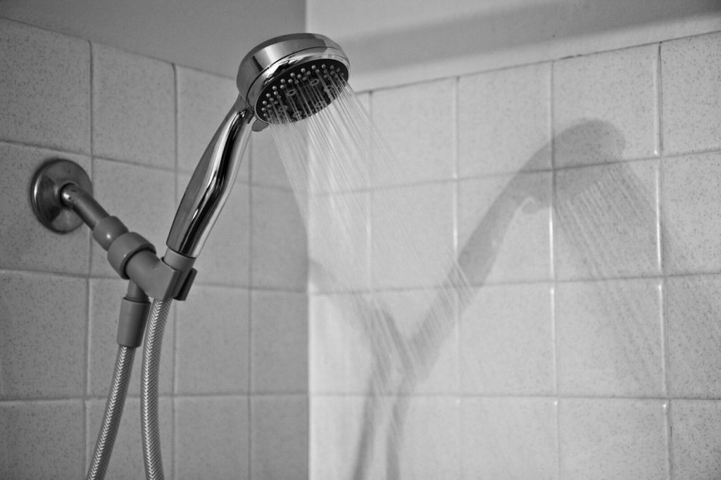 White ceramic wall tiles around a shower
