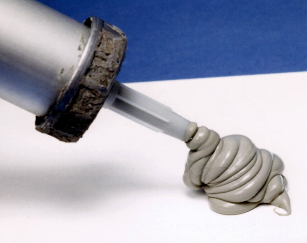 Silicone sealant being extruded from a cartridge nozzle
