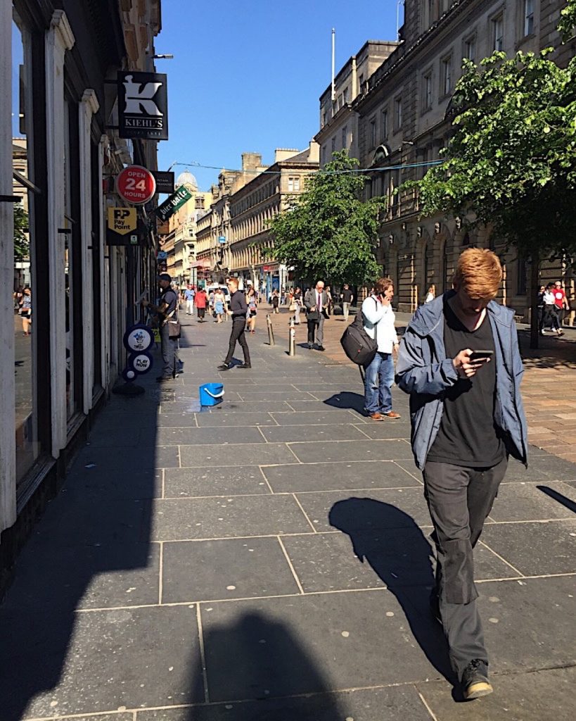 Large natural stone paving flags laid across a city pavement