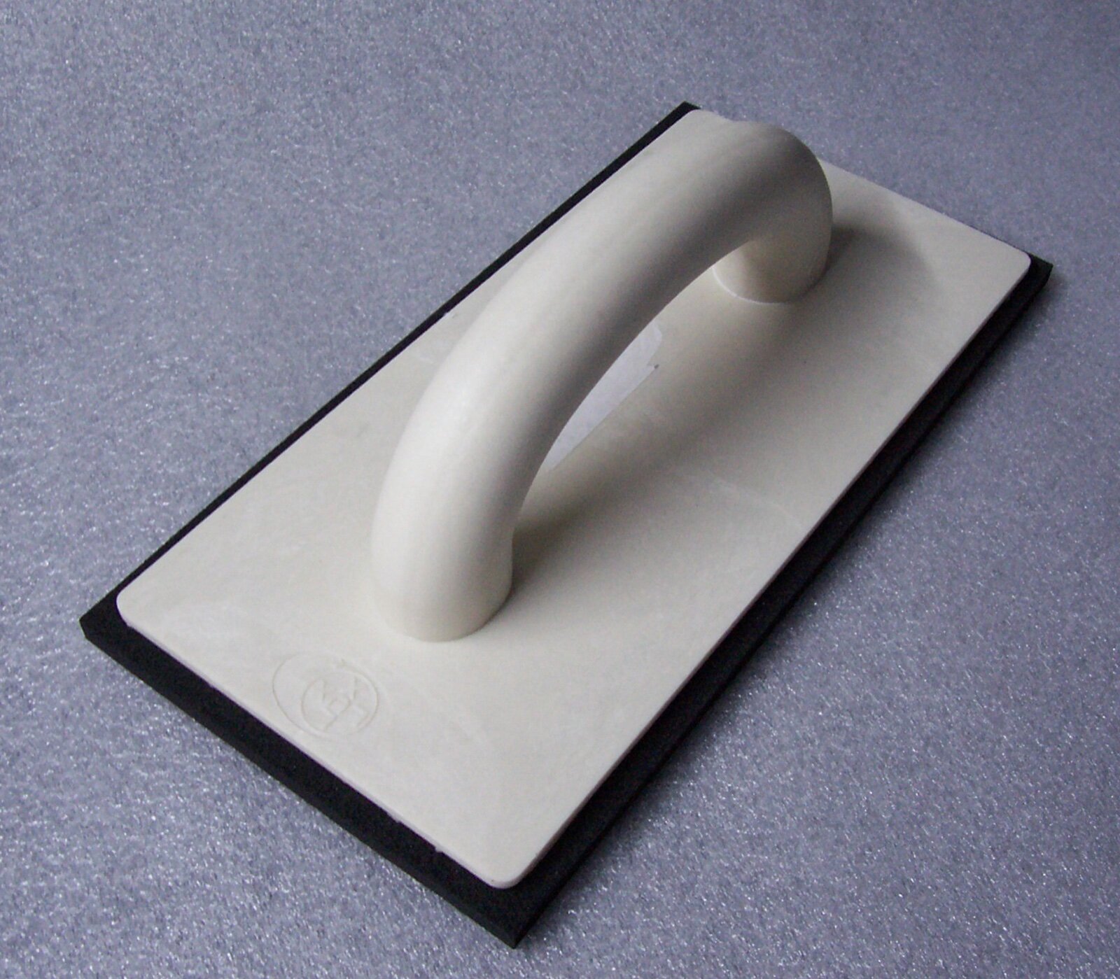Rubber grout float with a white handle