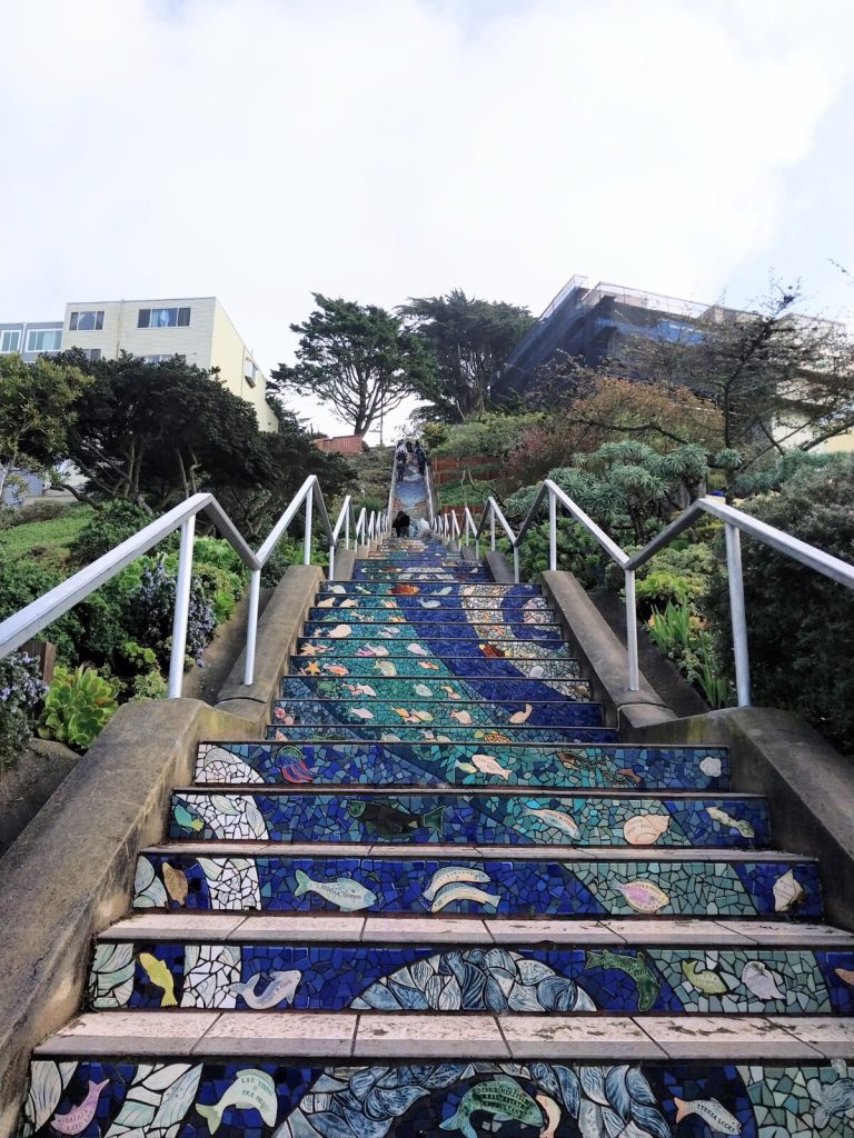 Mosaic tiled concrete steps with metal handrails