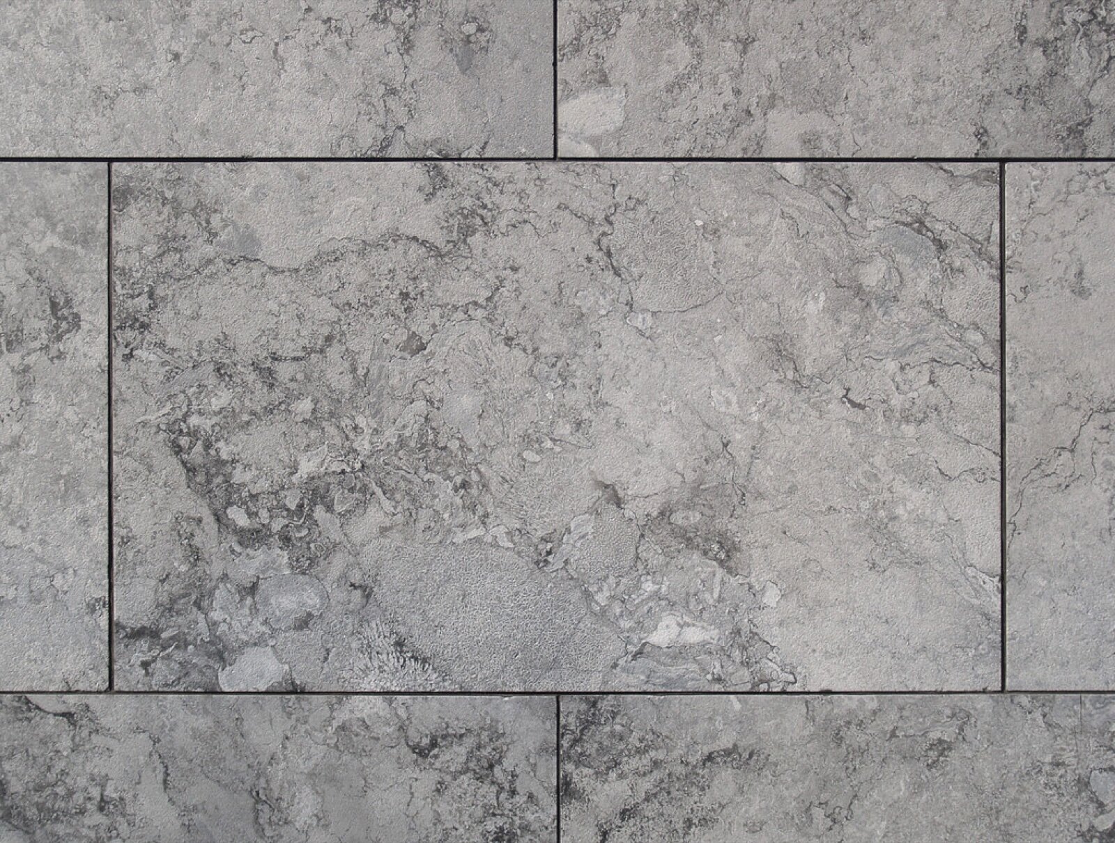 Large grey natural stone floor slabs with fine joints