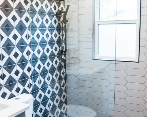 Walk in shower with patterned tiles
